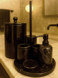 Luxury Toros black marble bathroom accessory set with silver accents displayed on a dark marble countertop, featuring lotion dispenser, cotton jar, toothbrush holder, soap dish, tray, waste basket, and toilet brush — handcrafted Turkish marble décor by Creative Home Designs,BAS-KRYKK-TOROS-BLABla-S7,BAS-KRYKK-TOROS-BLABla-S5