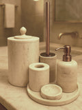 Luxury beige travertine marble bathroom accessory set displayed on a light stone countertop, featuring lotion dispenser, cotton jar, toothbrush holder, soap dish, tray, waste basket, and toilet brush — handcrafted Turkish travertine décor by Creative Home Designs.BAS-KRYKK-TRVTN-Cop-S7,BAS-KRYKK-TRVTN-Cop-S5