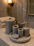 Luxury grey Afyon marble bathroom accessory set with gray accents displayed on a grey marble countertop, featuring lotion dispenser, cotton box, toothbrush holder, soap dish, tray, waste basket, and toilet brush — handcrafted Turkish marble décor by Creative Home Designs,BAS-KRYKK-AFYON-GRESil-S7,BAS-KRYKK-AFYON-GRESil-S5