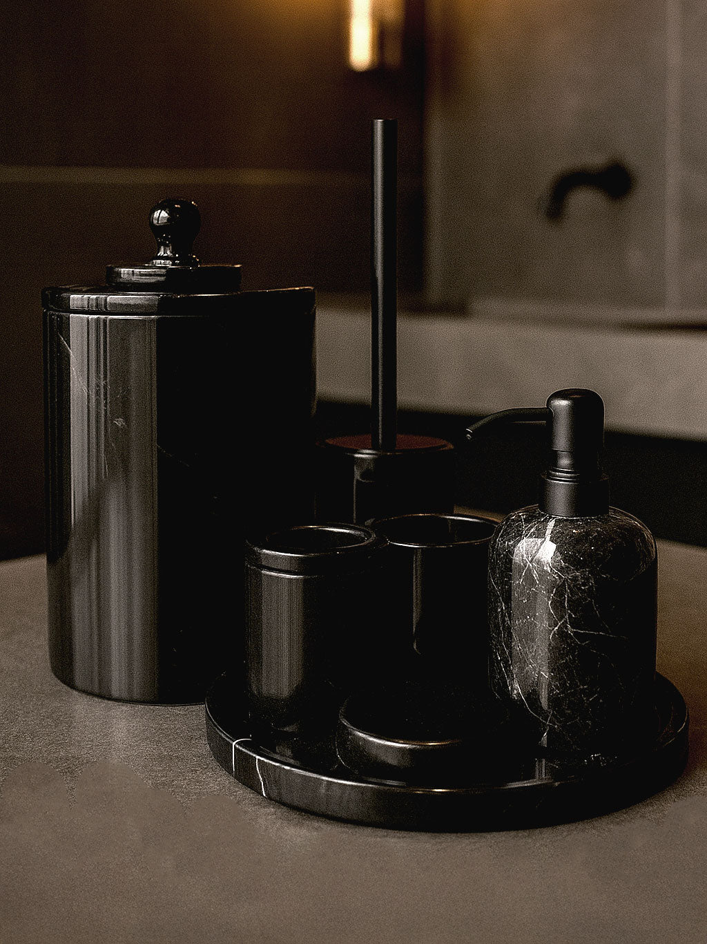 Luxury Toros black marble bathroom accessory set with silver accents displayed on a dark marble countertop, featuring lotion dispenser, cotton jar, toothbrush holder, soap dish, tray, waste basket, and toilet brush — handcrafted Turkish marble décor by Creative Home Designs,BAS-KRYKK-TOROS-BLABla-S7,BAS-KRYKK-TOROS-BLABla-S5
