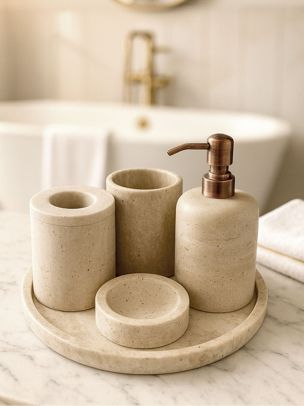 Luxury beige travertine marble bathroom accessory set displayed on a light stone countertop, featuring lotion dispenser, cotton jar, toothbrush holder, soap dish, tray, waste basket, and toilet brush — handcrafted Turkish travertine décor by Creative Home Designs.BAS-KRYKK-TRVTN-Cop-S7,BAS-KRYKK-TRVTN-Cop-S5