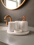 Luxury pearl white Afyon marble bathroom accessory set with copper accents displayed on a black marble countertop, featuring lotion dispenser, cotton box, toothbrush holder, soap dish, tray, waste basket, and toilet brush — handcrafted Turkish marble décor by Creative Home Designs,BAS-KRYKK-AFYON-PEARLCop-S7,BAS-KRYKK-AFYON-PEARLCop-S5