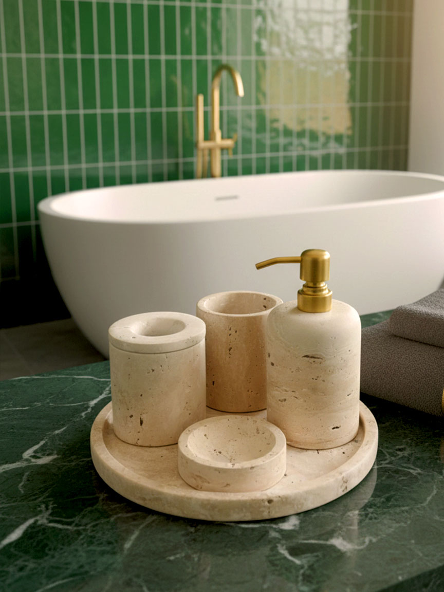 Luxury beige travertine marble bathroom accessory set displayed on a light stone countertop, featuring lotion dispenser, cotton jar, toothbrush holder, soap dish, tray, waste basket, and toilet brush — handcrafted Turkish travertine décor by Creative Home Designs.BAS-KRYKK-TRVTN-Go-S7,BAS-KRYKK-TRVTN-Go-S5