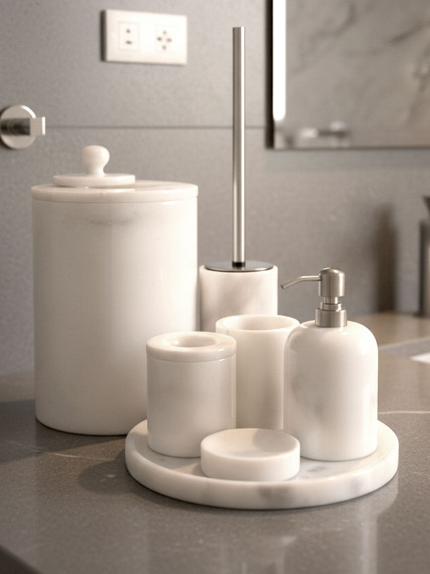 Luxury pearl white Afyon marble bathroom accessory set with silver accents displayed on a black marble countertop, featuring lotion dispenser, cotton box, toothbrush holder, soap dish, tray, waste basket, and toilet brush — handcrafted Turkish marble décor by Creative Home Designs,BAS-KRYKK-AFYON-PEARLSil-S5,BAS-KRYKK-AFYON-PEARLSil-S7