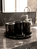 Luxury Toros black marble bathroom accessory set with silver accents displayed on a dark marble countertop, featuring lotion dispenser, cotton jar, toothbrush holder, soap dish, tray, waste basket, and toilet brush — handcrafted Turkish marble décor by Creative Home Designs,BAS-KRYKK-TOROS-BLASil-S7,BAS-KRYKK-TOROS-BLASil-S5