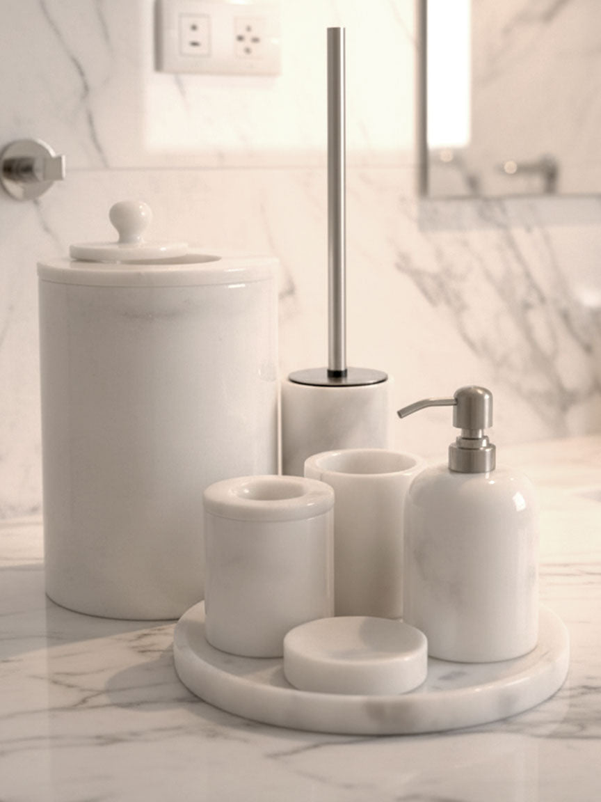 Luxury pearl white Afyon marble bathroom accessory set with silver accents displayed on a black marble countertop, featuring lotion dispenser, cotton box, toothbrush holder, soap dish, tray, waste basket, and toilet brush — handcrafted Turkish marble décor by Creative Home Designs,BAS-KRYKK-AFYON-PEARLSil-S5,BAS-KRYKK-AFYON-PEARLSil-S7