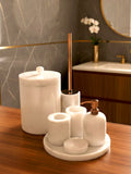 Luxury pearl white Afyon marble bathroom accessory set with copper accents displayed on a black marble countertop, featuring lotion dispenser, cotton box, toothbrush holder, soap dish, tray, waste basket, and toilet brush — handcrafted Turkish marble décor by Creative Home Designs,BAS-KRYKK-AFYON-PEARLCop-S7,BAS-KRYKK-AFYON-PEARLCop-S5