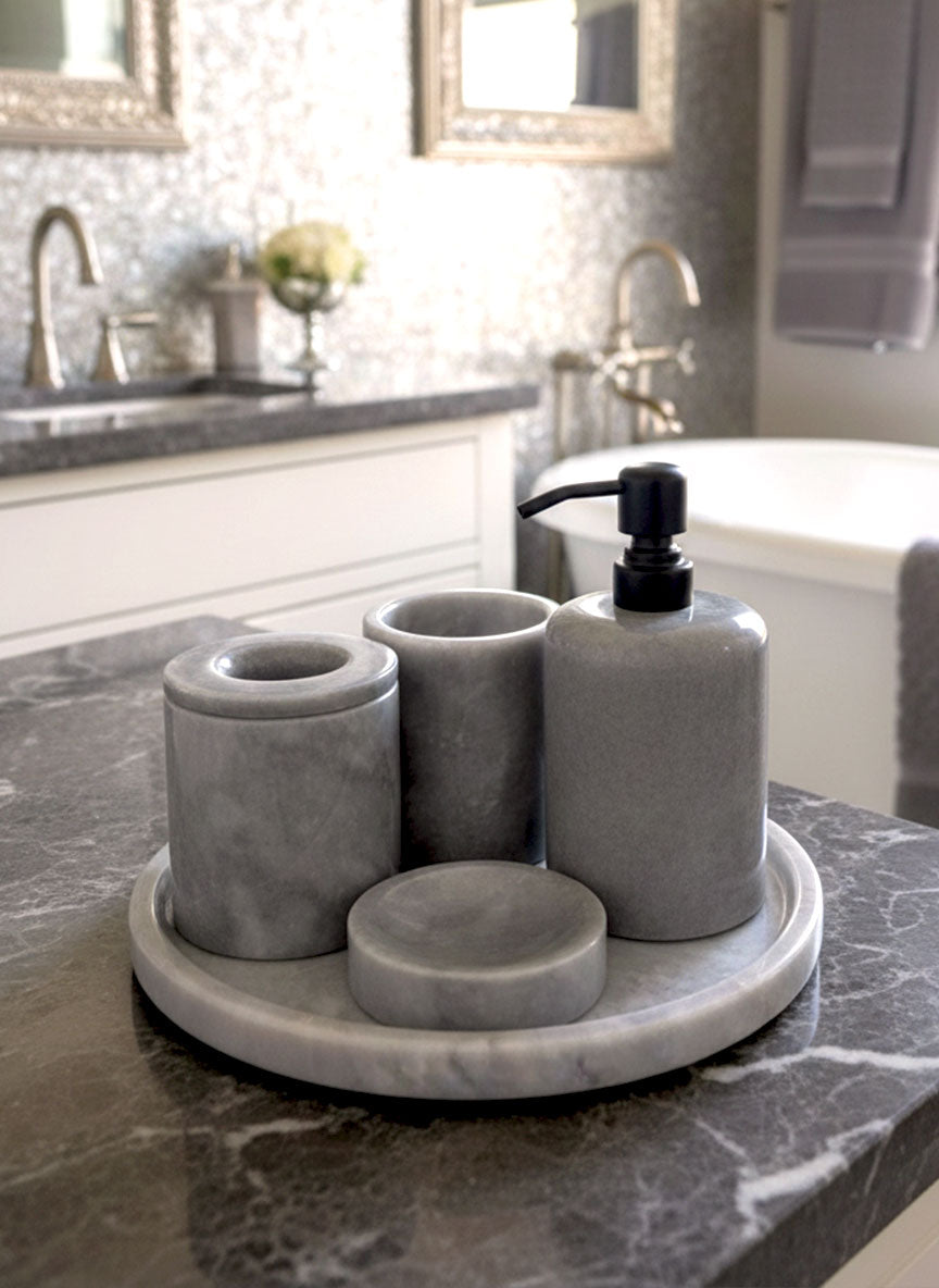 Luxury pearl white Afyon marble bathroom accessory set with gray accents displayed on a grey marble countertop, featuring lotion dispenser, cotton box, toothbrush holder, soap dish, tray, waste basket, and toilet brush — handcrafted Turkish marble décor by Creative Home Designs,BAS-KRYKK-AFYON-GREBla-S7,BAS-KRYKK-AFYON-GREBla-S5