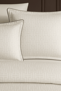 Creative Home Duvet Cover Set - Cream Jacquard Luxury Pattern Bedding set on a bed with a dark wall and small table in the background, DC-FC-RODEL-Cr-Q,DC-FC-RODEL-Cr-K