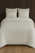 Creative Home Duvet Cover Set - Cream Jacquard Luxury Pattern Bedding set on a bed with a dark wall and small table in the background, DC-FC-RODEL-Cr-Q,DC-FC-RODEL-Cr-K