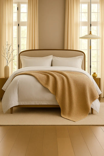 Bedroom with a neatly made bed styled with a 100% Turkish cotton waffle blanket, showing its textured waffle weave and cozy bedcover look as throw blanket by Creative Home.BB-DesH-WaBlnkt-Latte-6070,BB-DesH-WaBlnkt-Latte-Tw,BB-DesH-WaBlnkt-Latte-Q,BB-DesH-WaBlnkt-Latte-K,BB-DesH-WaBlnkt-Latte-100118,BB-DesH-WaBlnkt-Latte-100125
