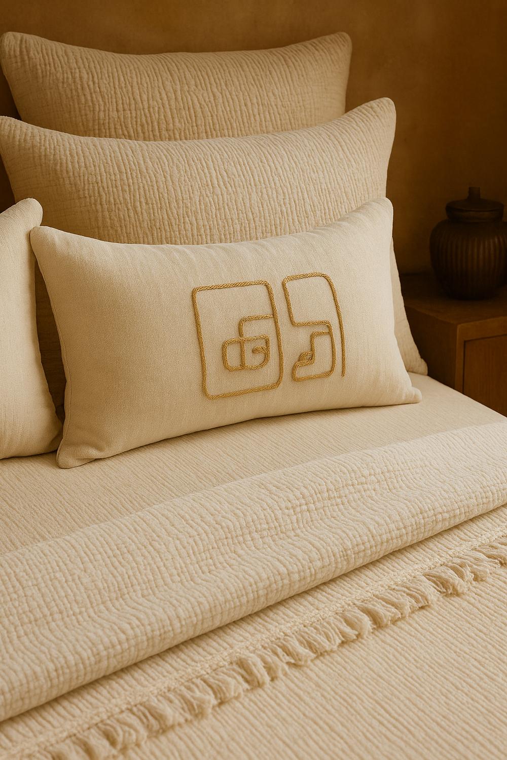 Luxury bedroom featuring a 100% muslin cotton cream gauze cloud blanket with matching pillows, styled on a bed beneath an arched window. BB-DesH-Blnkt-Cr-6070,BB-DesH-Blnkt-Cr-Tw, BB-DesH-Blnkt-Cr-Q,BB-DesH-Blnkt-Cr-K,BB-DesH-Blnkt-Cr-100118,BB-DesH-Blnkt-Cr-100125