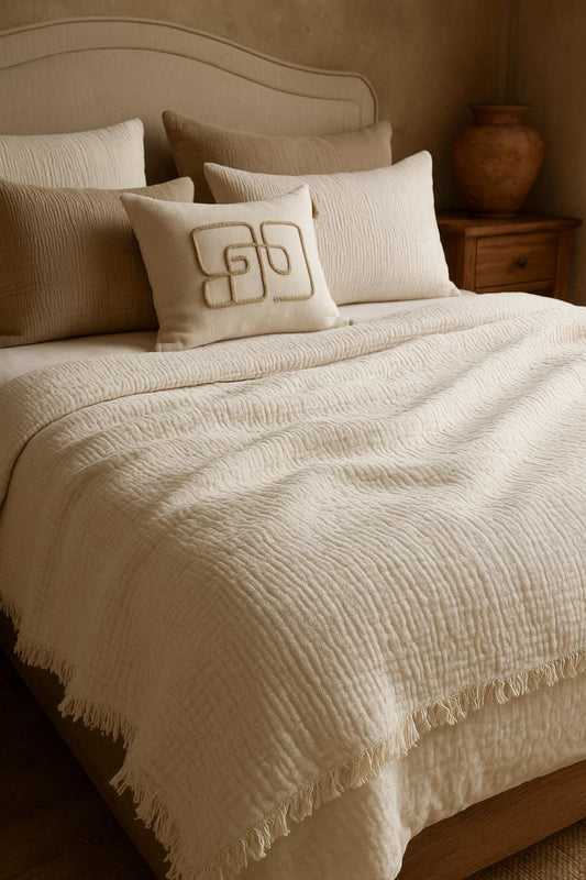 Luxury bedroom featuring a 100% muslin cotton cream gauze cloud blanket with matching pillows, styled on a bed beneath an arched window. BB-DesH-Blnkt-Cr-6070,BB-DesH-Blnkt-Cr-Tw, BB-DesH-Blnkt-Cr-Q,BB-DesH-Blnkt-Cr-K,BB-DesH-Blnkt-Cr-100118,BB-DesH-Blnkt-Cr-100125