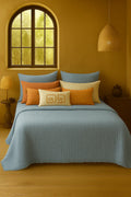 Luxury bedroom featuring a 100% muslin cotton Sky Blue gauze cloud blanket with matching pillows, styled on a bed beneath an arched window. BB-DesH-Blnkt-SkBlu-6070,BB-DesH-Blnkt-SkBlu-Tw,BB-DesH-Blnkt-SkBlu-Q,BB-DesH-Blnkt-SkBlu-K,BB-DesH-Blnkt-SkBlu-100118,BB-DesH-Blnkt-SkBlu-100125