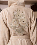 Woman wearing a beige Bamboo bathrobe by Creative Home, Gelin SPA Set with embroidery lace BRW-CH-GLNBei-Go-S-BO,BRW-CH-GLNBei-Go-S-BS,BRW-CH-GLNBei-Go-S-BST,BRW-CH-GLNBei-Go-M-BO,BRW-CH-GLNBei-Go-M-BS,BRW-CH-GLNBei-Go-M-BST,BRW-CH-GLNBei-Go-L-BO,BRW-CH-GLNBei-Go-L-BS,BRW-CH-GLNBei-Go-L-BST,BRW-CH-GLNBei-Go-XL-BO,BRW-CH-GLNBei-Go-XXL-BO,BRW-CH-GLNBei-Go-XXXL-BO,BRW-CH-GLNBei-Go-XL-BS,BRW-CH-GLNBei-Go-XXL-BS,BRW-CH-GLNBei-Go-XXXL-BS,BRW-CH-GLNBei-Go-XL-BST,BRW-CH-GLNBei-Go-XXL-BST,BRW-CH-GLNBei-Go-XXXL-BST