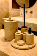 Luxury Toros beige gold marble bathroom accessory set with gold accents displayed on a dark marble countertop, featuring lotion dispenser, cotton jar, toothbrush holder, soap dish, tray, waste basket, and toilet brush — handcrafted Turkish marble décor by Creative Home Designs,BAS-KRYKK-TOROS-BEIBla-S7,BAS-KRYKK-TOROS-BEIBla-S5